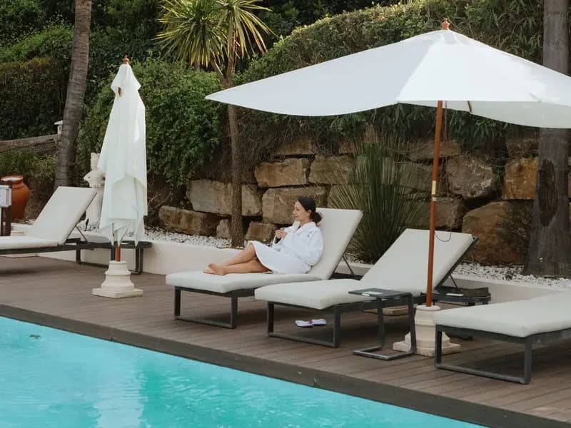 Guest relaxing on a sun lounger beside the pool at Shanti-Som Marbella